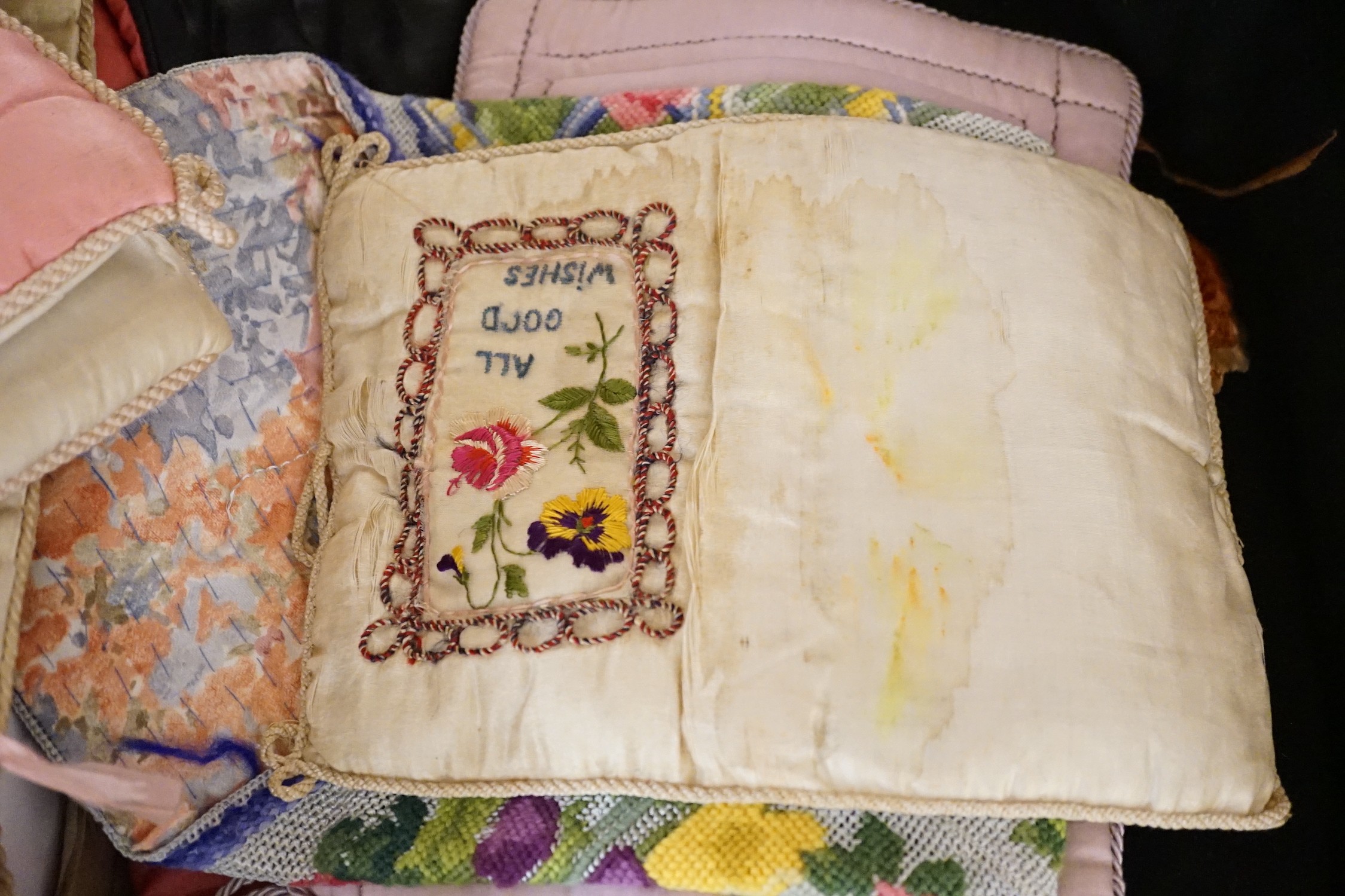 A large collection of mixed European textiles including ribbon worked pyjama cases, Indian painted textiles, a sample book of braidings etc